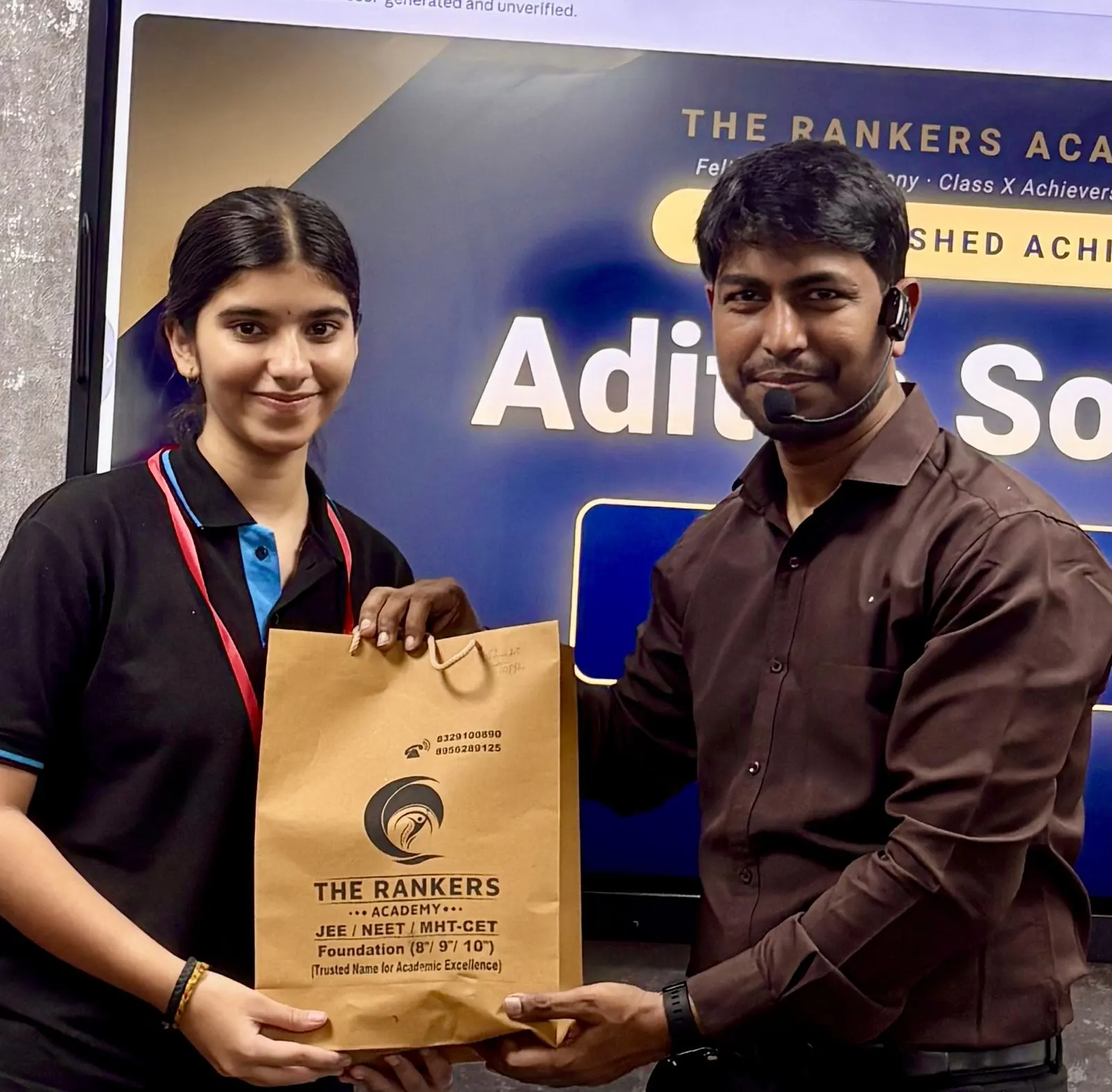 Teacher presenting a gift bag to a smiling student