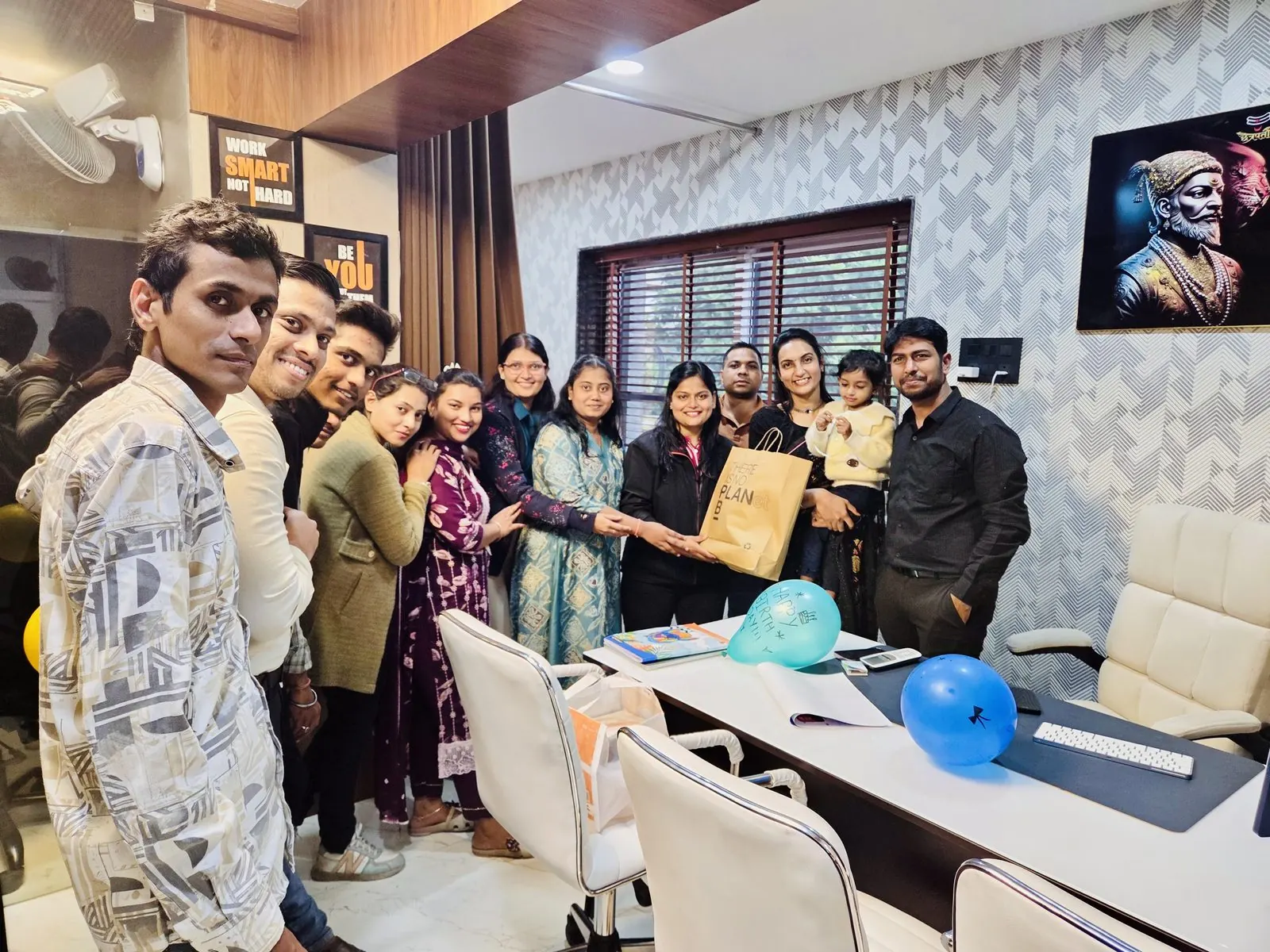 Faculty & students posing with bouquets and gifts
