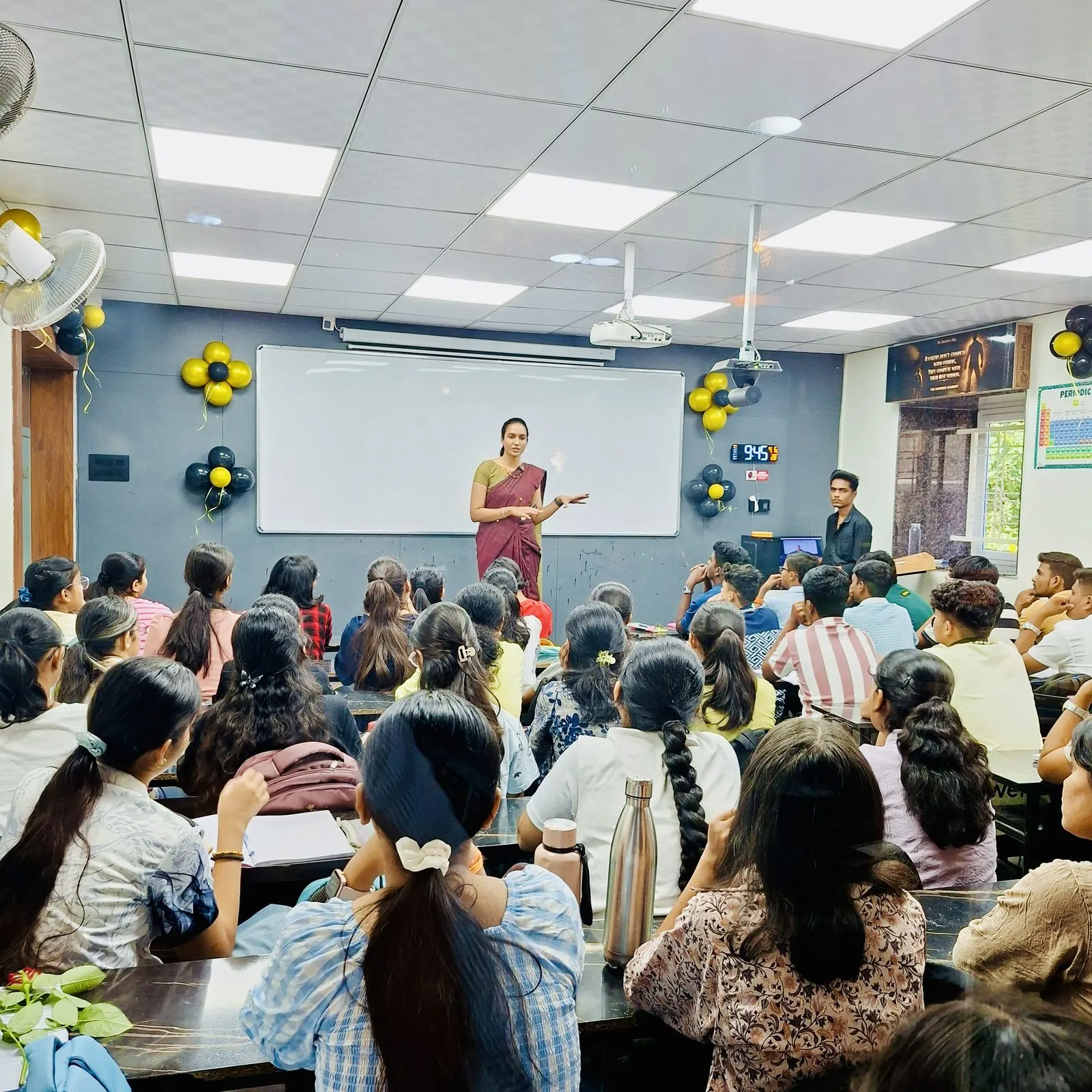 Teacher lecturing under festive classroom decor