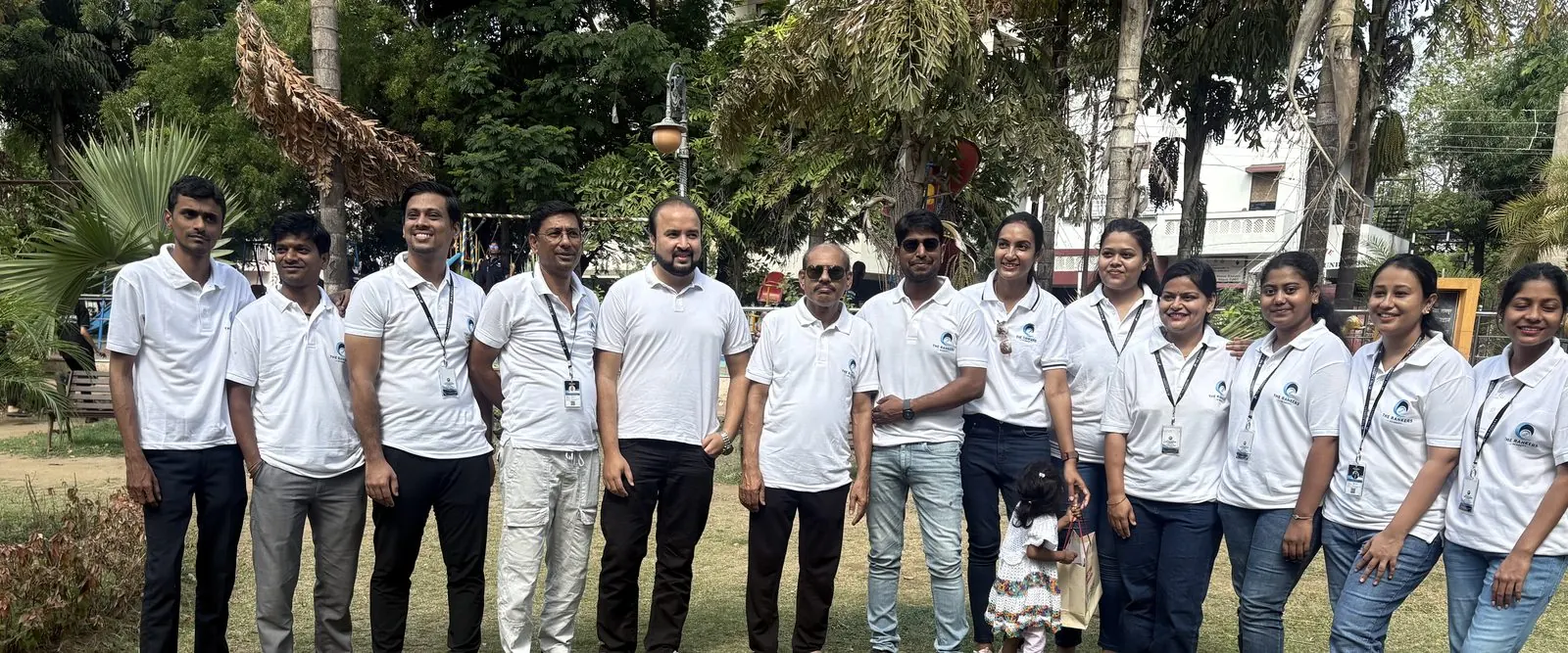 Large group of white-shirt students with faculty