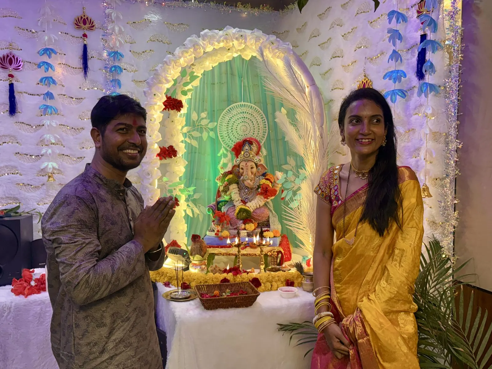 Founders in traditional attire near Ganesh idol