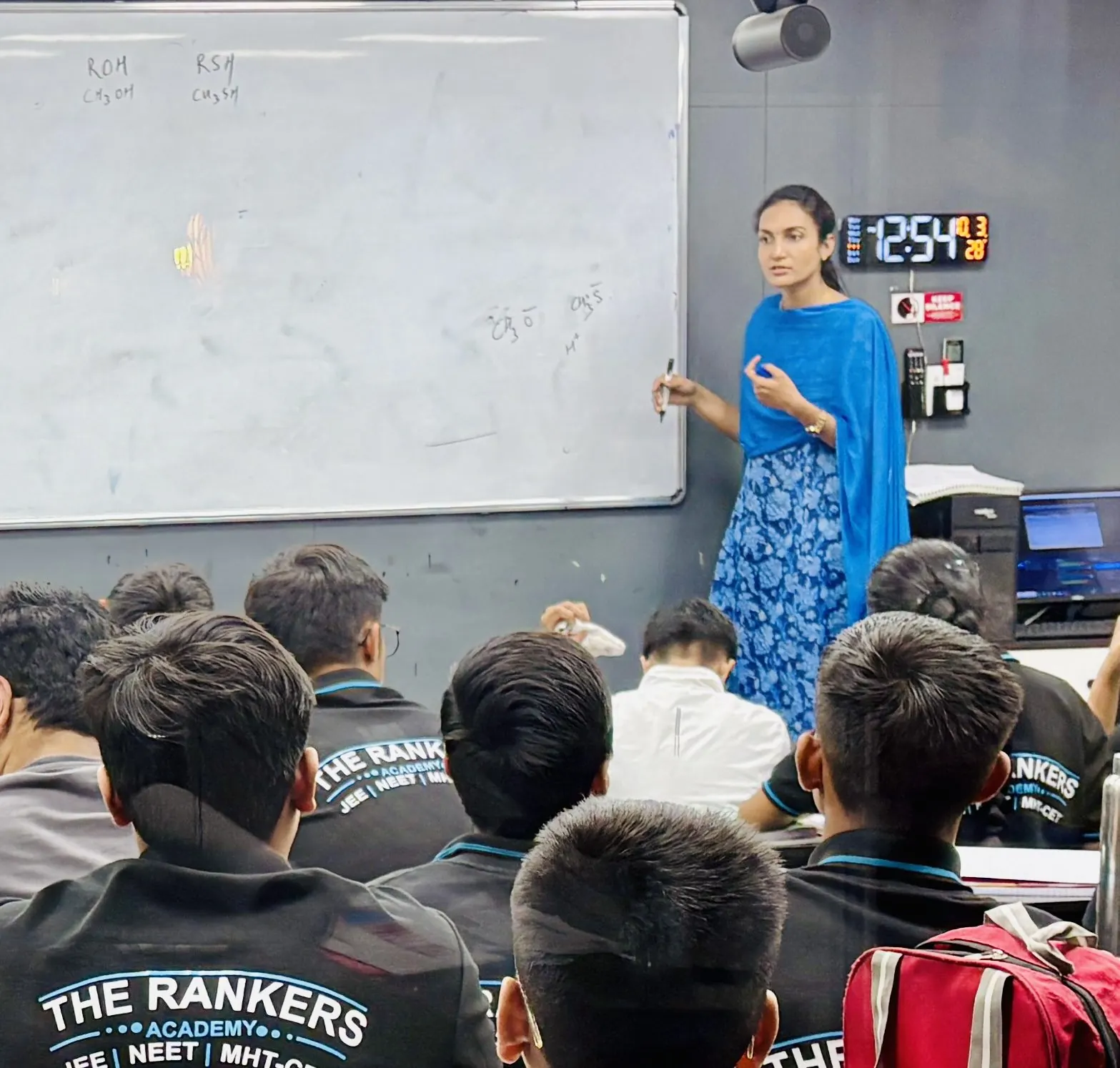 Teacher explaining a solved problem on the whiteboard